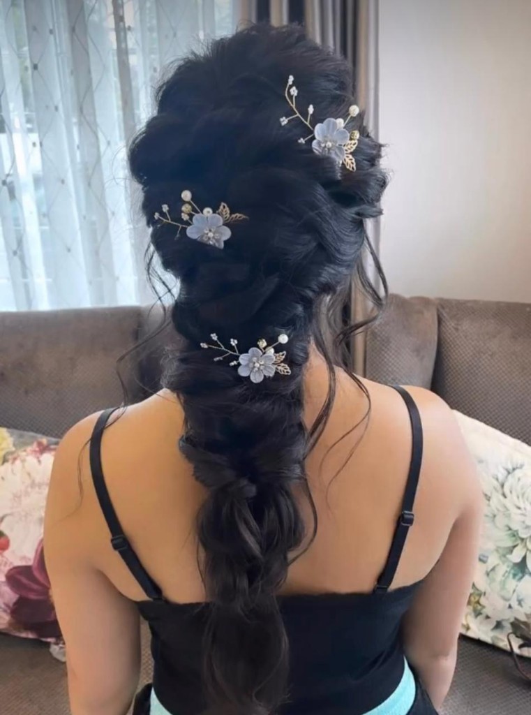 Elegant dark bridal updo with floral pins by Hairstelle