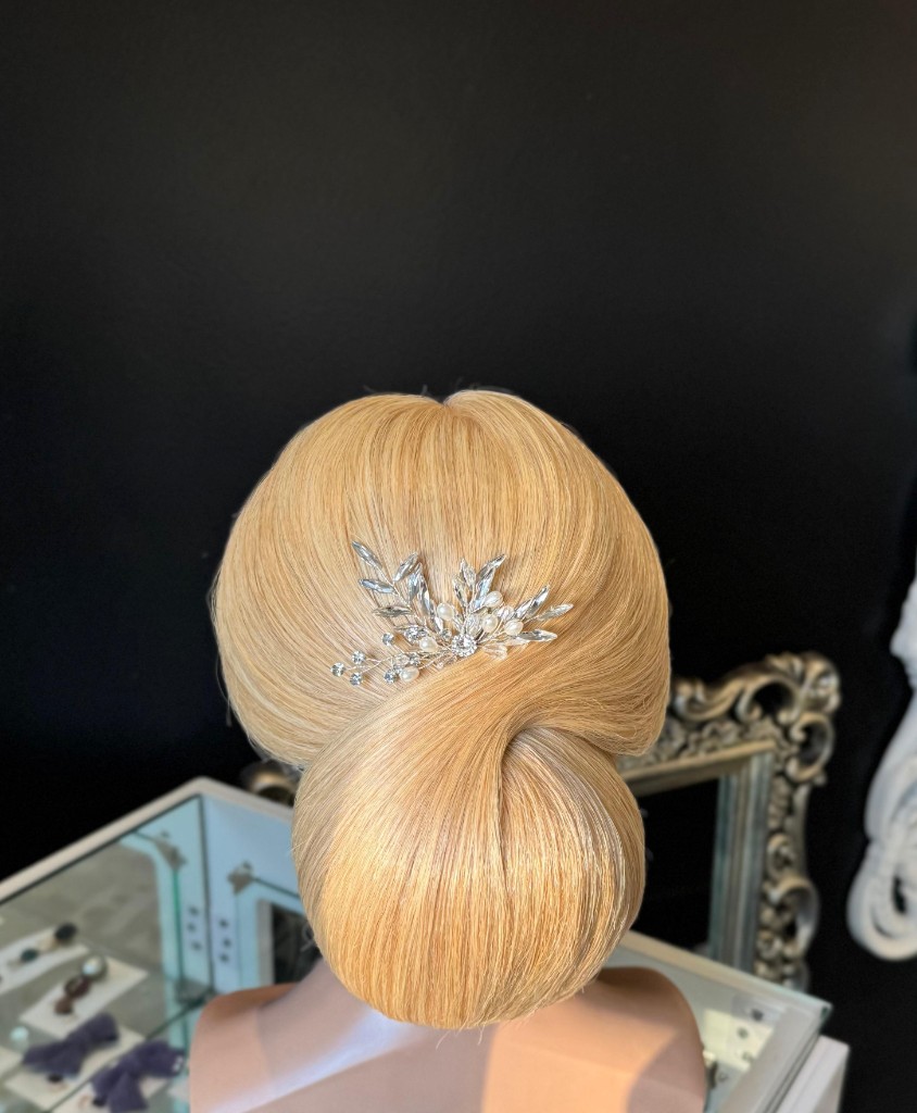 Structured blonde bridal updo created by Hairstelle