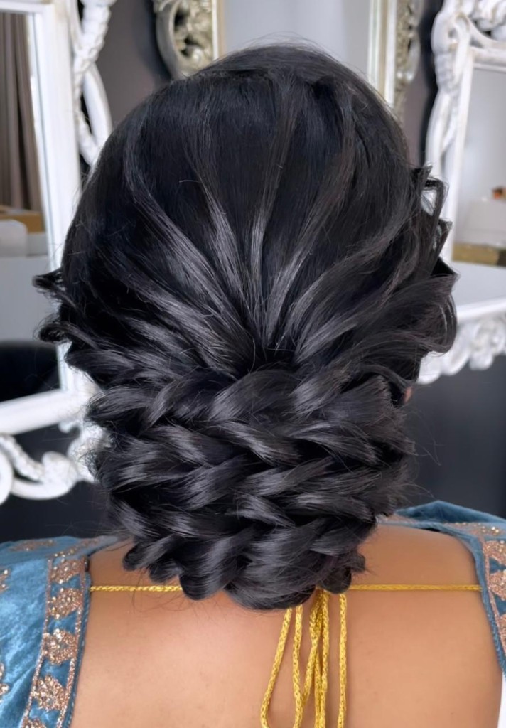 Low braided black updo by Hairstelle